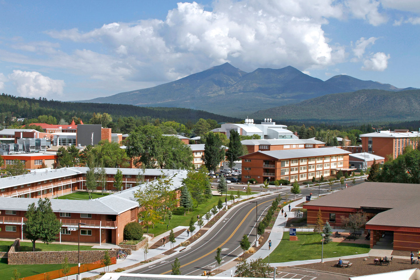 Northern Arizona University campus in the summer showing buildings in the foreground and the Peaks in the background