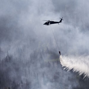 An Alaska Army National Guard UH-60 Black Hawk helicopter from 1st Battalion, 207th Aviation Regiment, drops approximately 700 gallons of water from a “Bambi Bucket” on to the Stetson Creek Fire near Cooper Landing, Alaska, June 17. Two AKARNG Black Hawk helicopters flew a total of 200 bucket missions, dumping more than 144,000 gallons of water on the 300-acre Stetson Creek Fire on the Kenai Peninsula. (U.S. Army National Guard photo by Sgt. Balinda O’Neal)